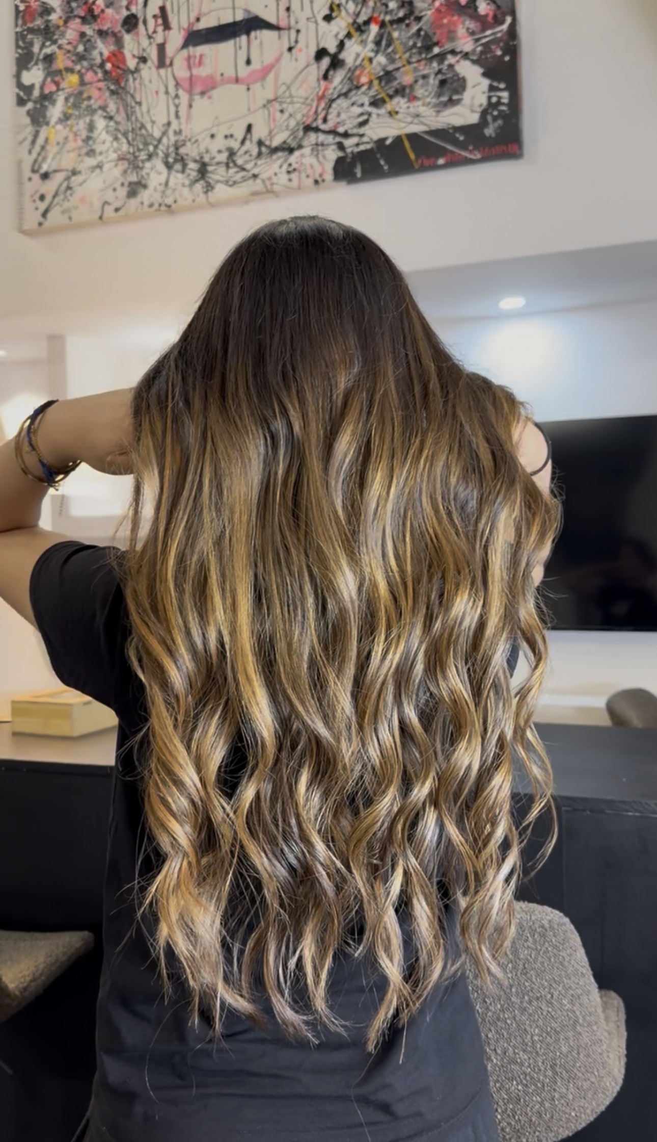 Vue de dos de cheveux très longs, balayage caramel doré et blond miel sur base brune, ondulations souples